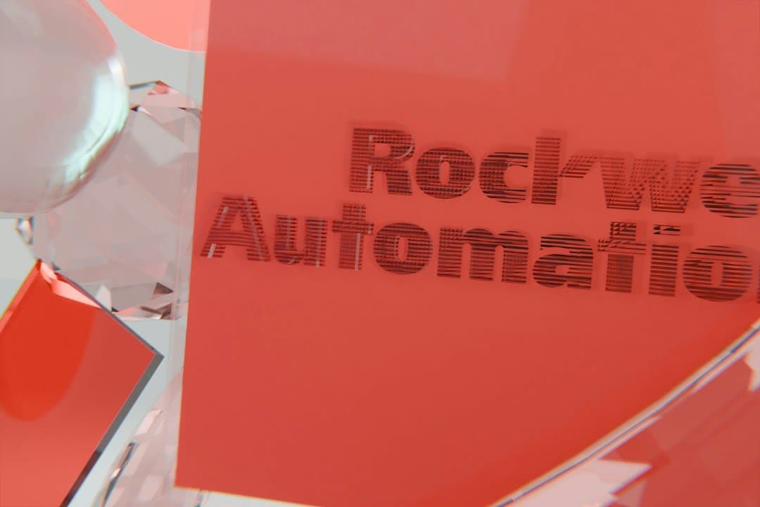 Rockwell automation text on a red surface with reflective elements