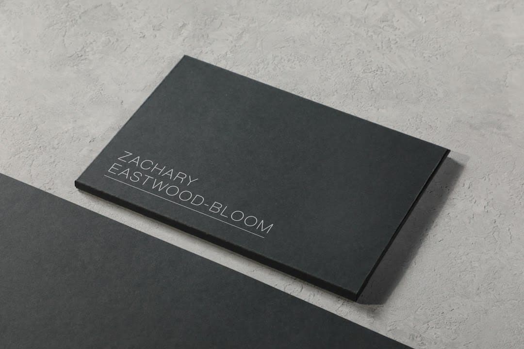 A black business card sitting on top of a table